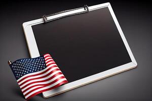 Blank slate board over American flag. Happy Labor Day. photo