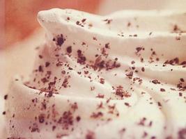 small appetizing white meringues on a plate in close-up photo