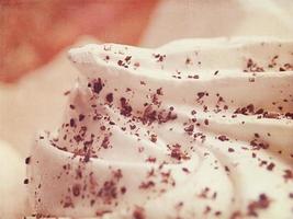 small appetizing white meringues on a plate in close-up photo