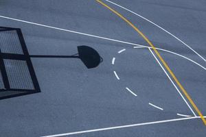 basketball hoop shadow on the basketball court photo