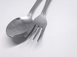 A close up of spoon and fork with white background photo