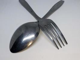 A close up of spoon and fork with white background photo