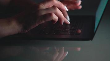 Hands of woman office worker typing on the keyboard at night video