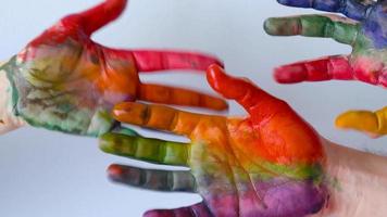 Creative concept - painted hands cheerfully move their fingers video