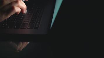 Hands of woman office worker typing on the keyboard at night video