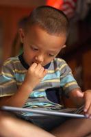 Boy bored playing computer games photo