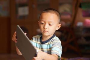 Boy bored playing computer games photo