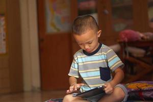Boy bored playing computer games photo