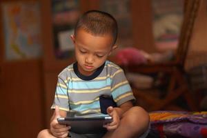 Boy bored playing computer games photo