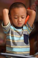 Boy bored playing computer games photo