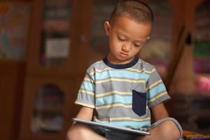 Boy bored playing computer games photo
