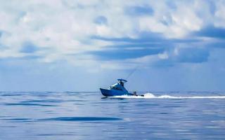 Boat trip Cancun Mexico to Island with deep blue seascape. photo