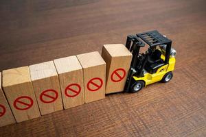 A forklift erects a restrictive barrier. Create a new restriction. Provide new sanctions and restrictions. Laws and regulations. Bans and taboo. Stop work, freeze and cancel. Block VPN services. photo