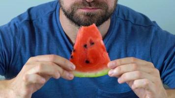 Bearded man eats a juicy watermelon video