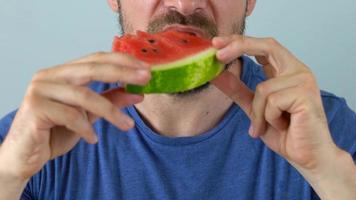 Bearded man eats a juicy watermelon video