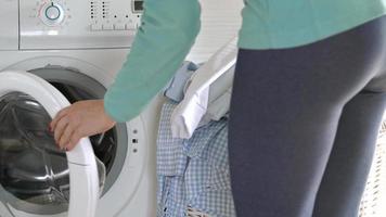 Woman gets laundry from washing machine video