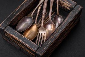 Vintage rectangular shabby wooden box with spoons and forks photo