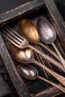 Vintage rectangular shabby wooden box with spoons and forks photo