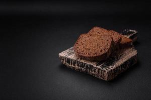 Loaf of fresh crispy brown bread with grains and seeds photo