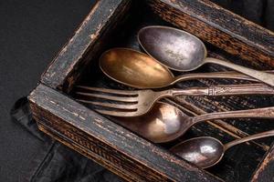 Vintage rectangular shabby wooden box with spoons and forks photo