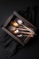 Vintage rectangular shabby wooden box with spoons and forks photo