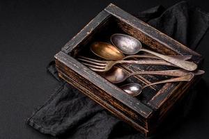 Vintage rectangular shabby wooden box with spoons and forks photo
