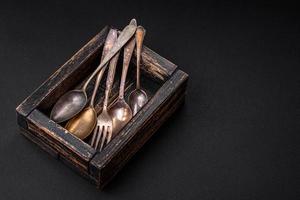 Vintage rectangular shabby wooden box with spoons and forks photo