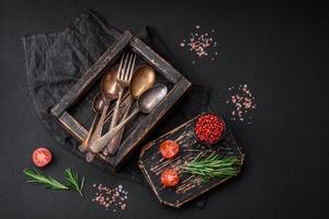 Vintage rectangular shabby wooden box with spoons and forks photo