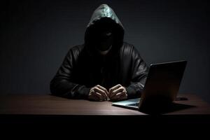 hacker vistiendo negro capucha utilizando ordenador portátil computadora mientras trabajando en oscuro antecedentes. ai generado foto