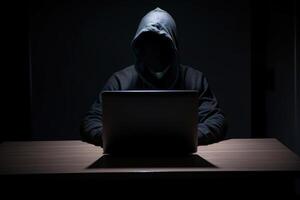 hacker vistiendo negro capucha utilizando ordenador portátil computadora mientras trabajando en oscuro antecedentes. ai generado foto