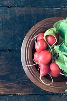 radishes on a wooden plate photo