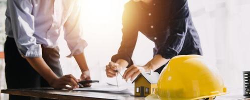 Architect concept, Architects working with blueprints in the office, Vintage Effect photo