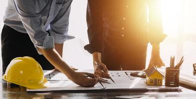 Architect concept, Architects working with blueprints in the office, Vintage Effect photo