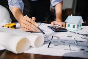 Architect concept, Architects working with blueprints in the office, Vintage Effect photo