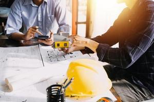 Architect concept, Architects working with blueprints in the office, Vintage Effect photo