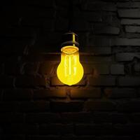 Yellow lighting bulb on dark background. Illustration photo