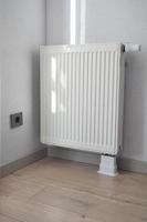 heating radiator under window in the room photo