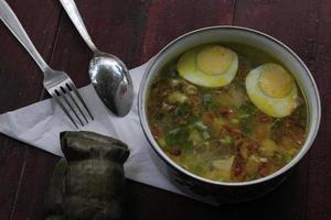 Indonesian special food Soto served with Buras photo