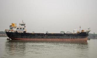 Dhaka, Dhaka, Bangladesh, 2023, A big tanker ship on the river full body view. Tanker ship moving on the river. Beautiful scenery of nature and an old water vessel. Modern tanker ship photo