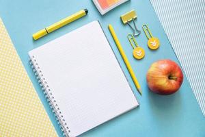 School supplies. Yellow and blue colors. Empty notebook. Flat lay composition. Space for text. photo