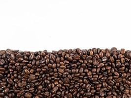 Arabica coffee beans roasted fragrant ready to make coffee that people like to drink placed on the white background looks beautiful photo