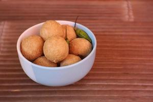 tahu pong is a kind of hollow fried tofu fried tofu which is cut into small rounds. On a white plate. Indonesian street food. photo