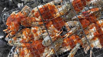 Top view fresh crabs cooked on bbq grill using coil. Gurman dish preparation. Oman video