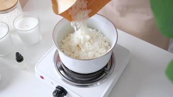 Woman making decorative aroma candle at table video