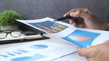 Hand written growth chart on paper at office desk video