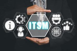 ITSM, information technology service management concept, Business person hand holding information technology service management icon on virtual screen. photo