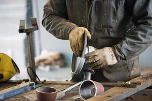 Hands of a worker with a grinder. photo