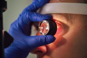 An ophthalmologist checks the fundus of the patient. photo