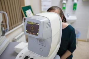 An ophthalmologist checks the fundus of the patient. photo