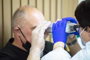 Optometrist picks up glasses for the patient. photo